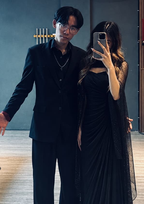 Mirror selfie, both of us in black, dressed for the evening