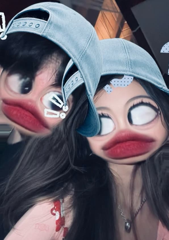 Pulling faces behind a silly filter, him in a denim cap